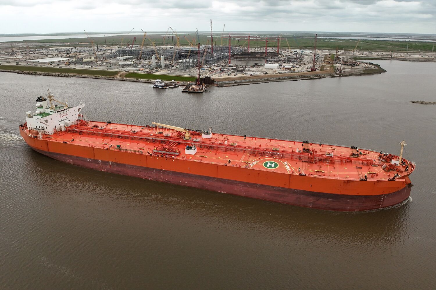 Cargo loading arms beside a chemical tanker at a terminal